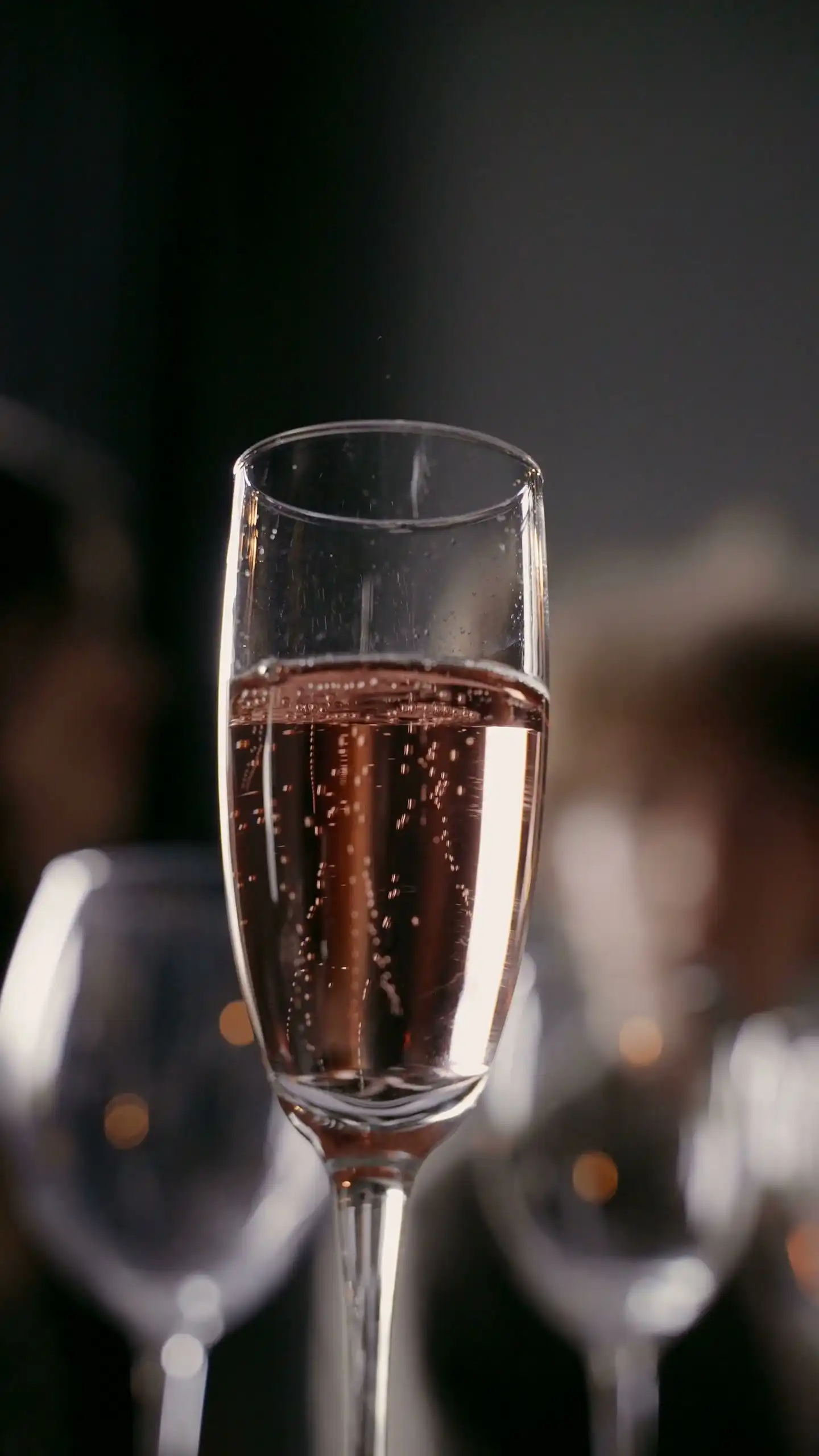A flute of pale pink sparkling wine