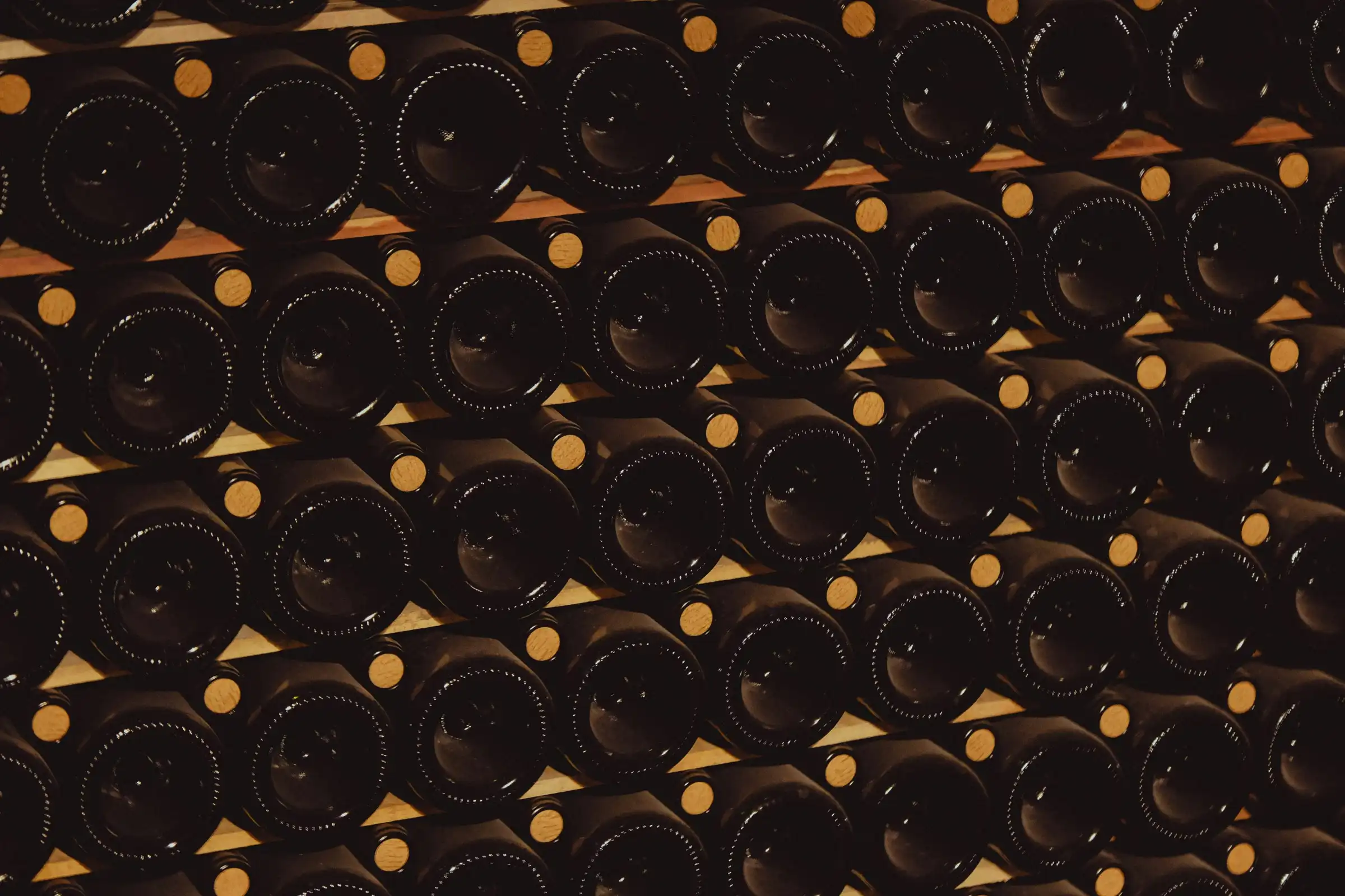 Bottle ends stacked in rows in a cellar