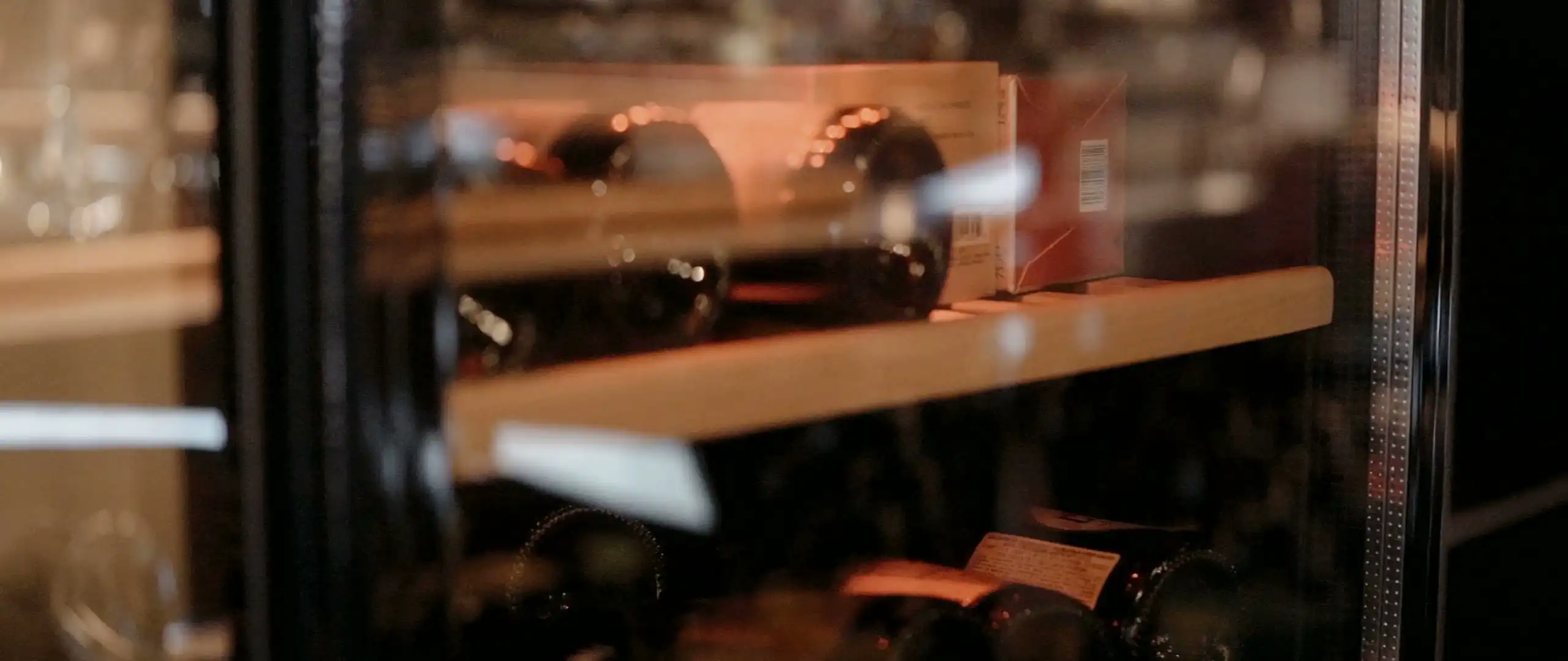 Bottles on cellar shelves in warm light